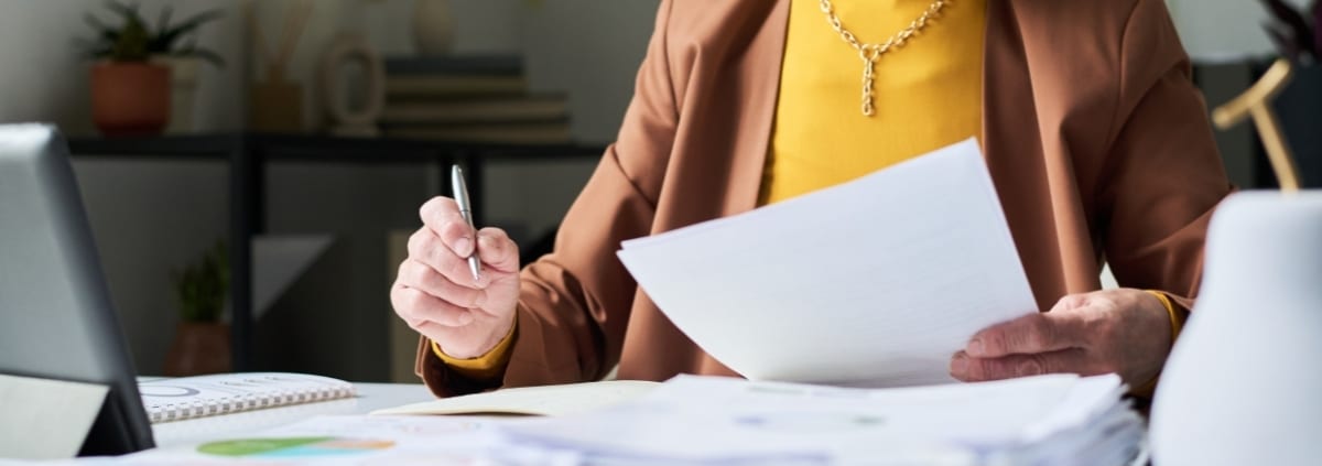 Landlord reviewing a rental application and screening documents with a potential tenant.