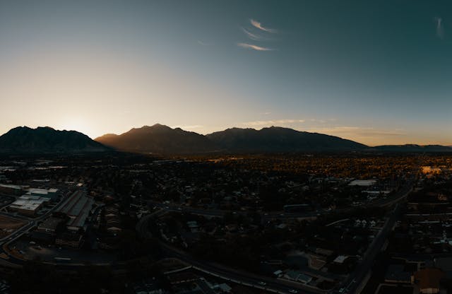 Mountain Range Surrounding a City at Sunrise