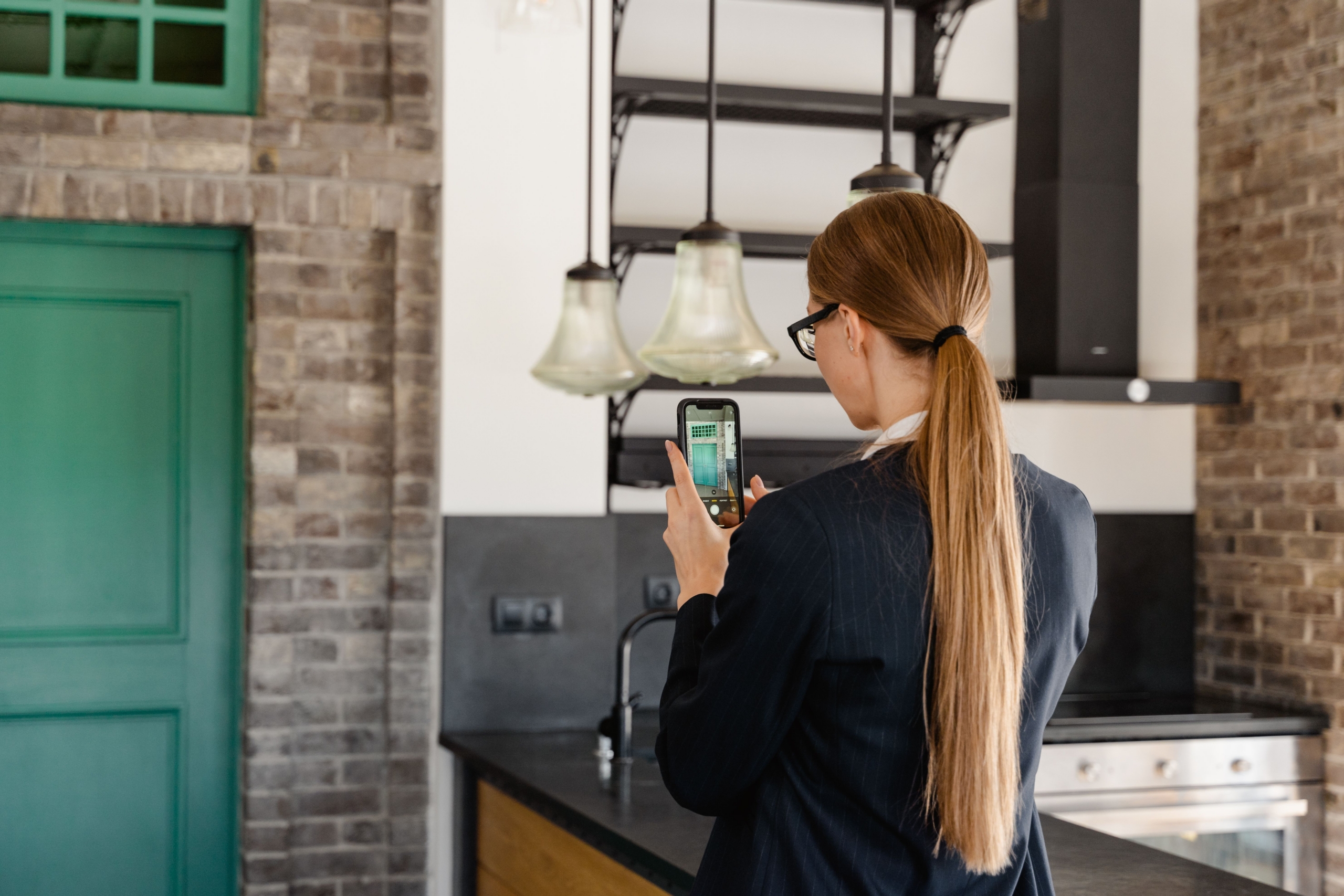 Utah property owner does a walkthrough in a kitchen with their phone out to document condition