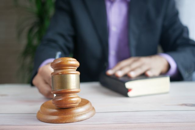 a person holding a wooden gavel