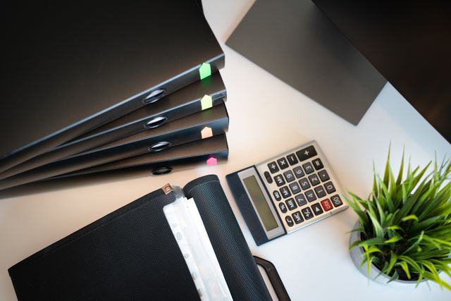 binders and a calculator on a desk