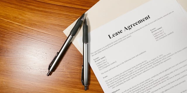 lease-agreement-on-wooden-surface-with-folder-and-pens