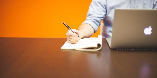a person working at a desk with a laptop