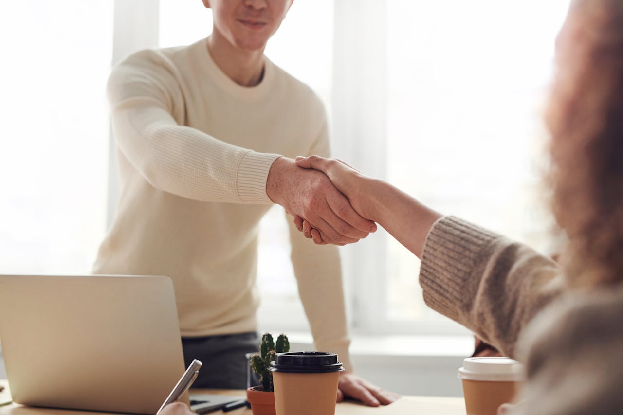 two-people-shaking-hands two people shaking hands